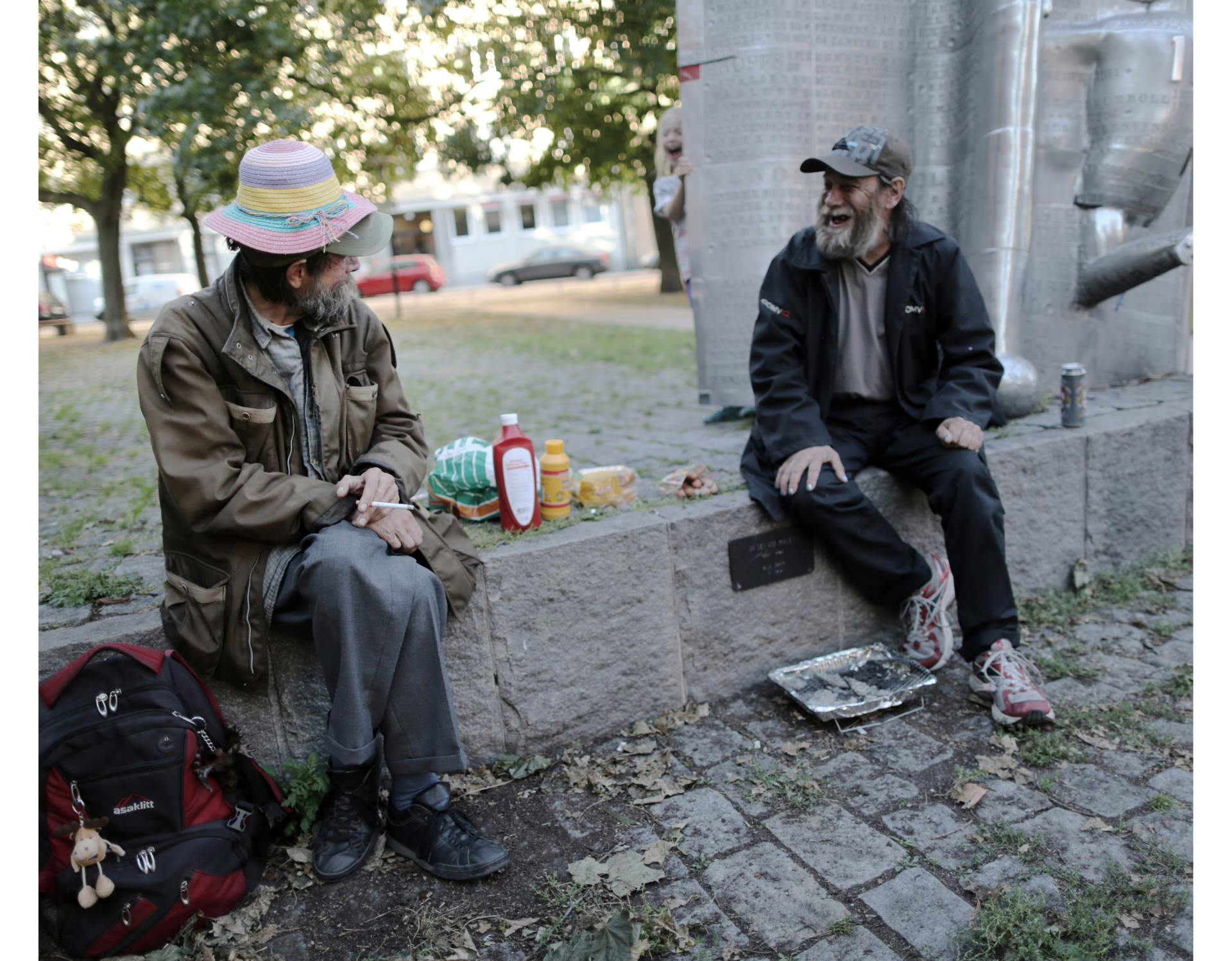 Matte and Pekka drinking beer and eating in a park in central Stockholm.